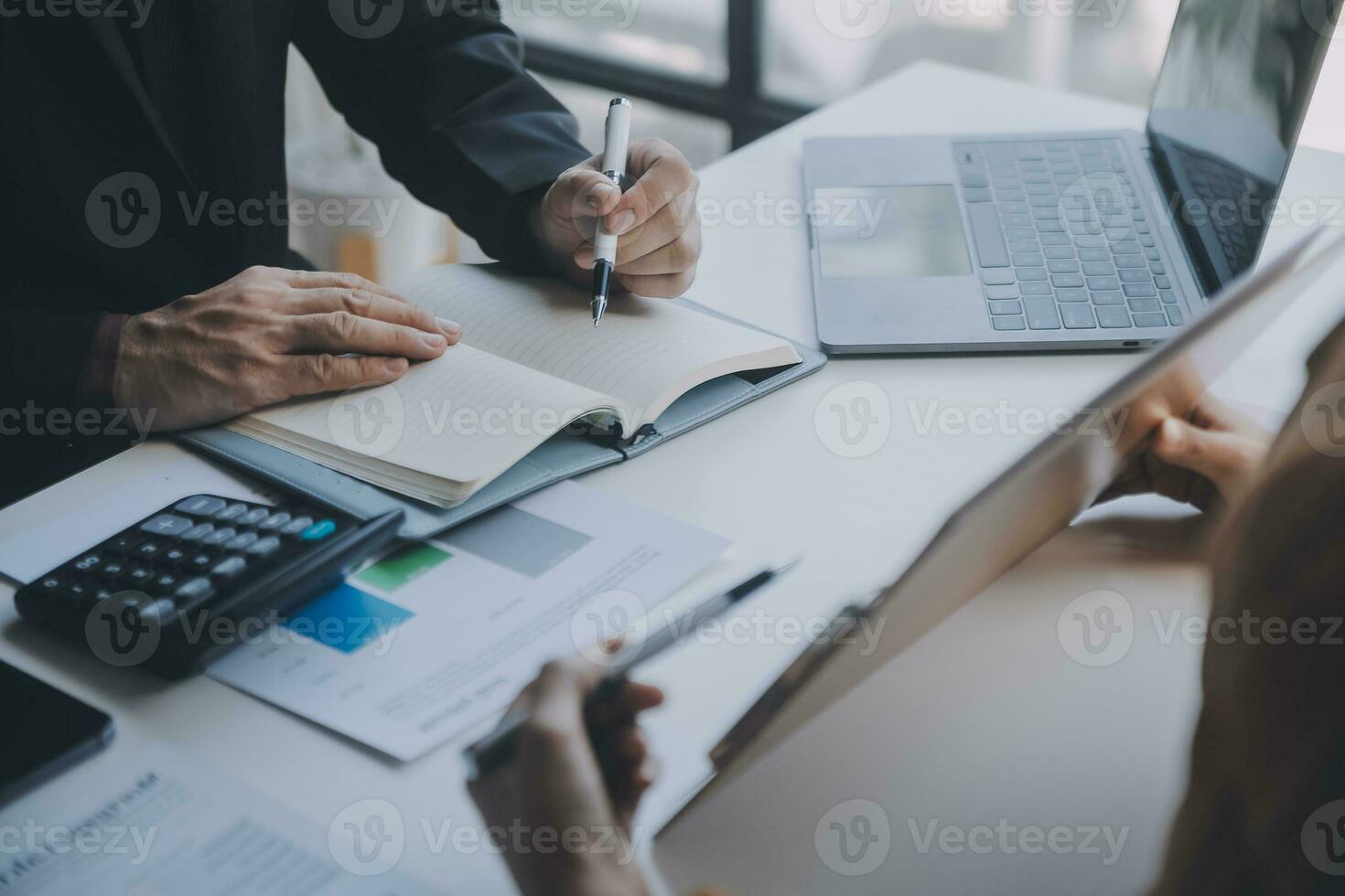 Financial analysts analyze business financial reports on a digital tablet planning investment project during a discussion at a meeting of corporate showing the results of their successful teamwork. photo