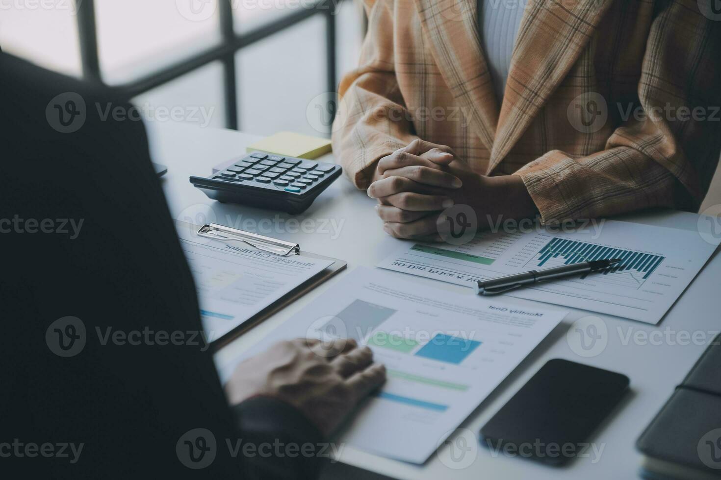 Financial analysts analyze business financial reports on a digital tablet planning investment project during a discussion at a meeting of corporate showing the results of their successful teamwork. photo