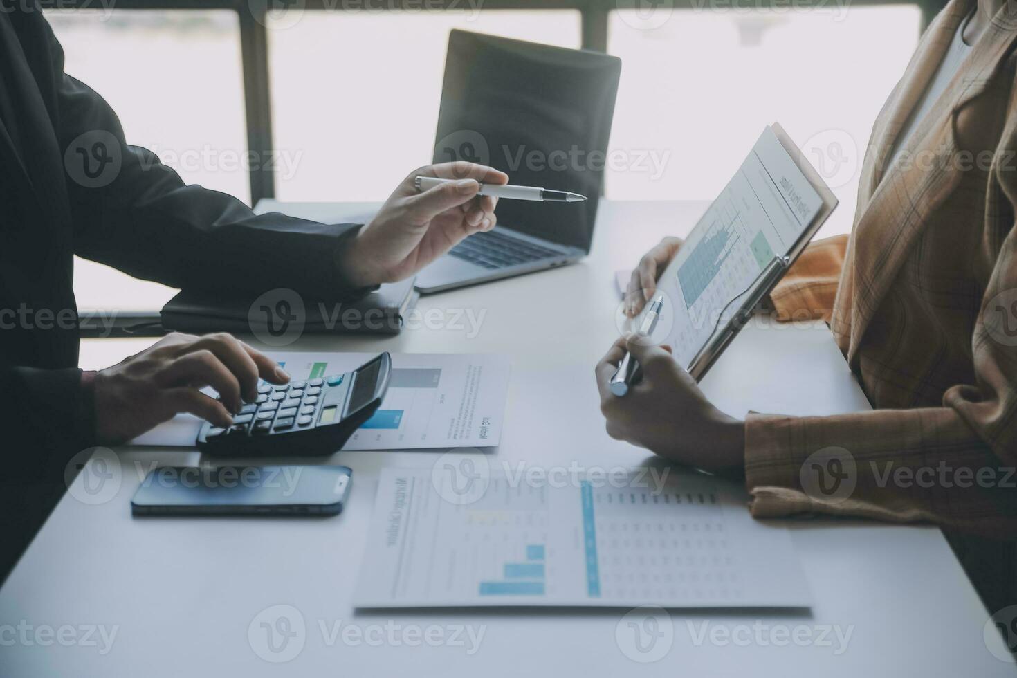 Financial analysts analyze business financial reports on a digital tablet planning investment project during a discussion at a meeting of corporate showing the results of their successful teamwork. photo