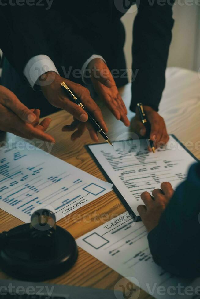 Consultation and conference of Male lawyers and professional businesswoman working and discussion having at law firm in office. Concepts of law, Judge gavel with scales of justice. photo