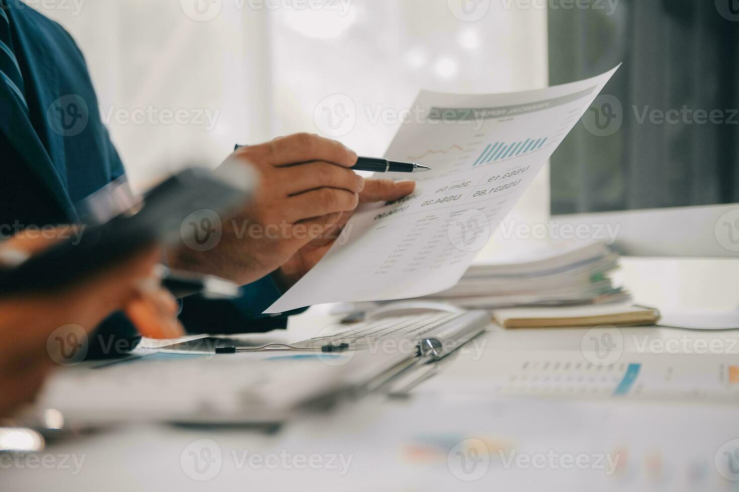 Financial analysts analyze business financial reports on a digital tablet planning investment project during a discussion at a meeting of corporate showing the results of their successful teamwork. photo