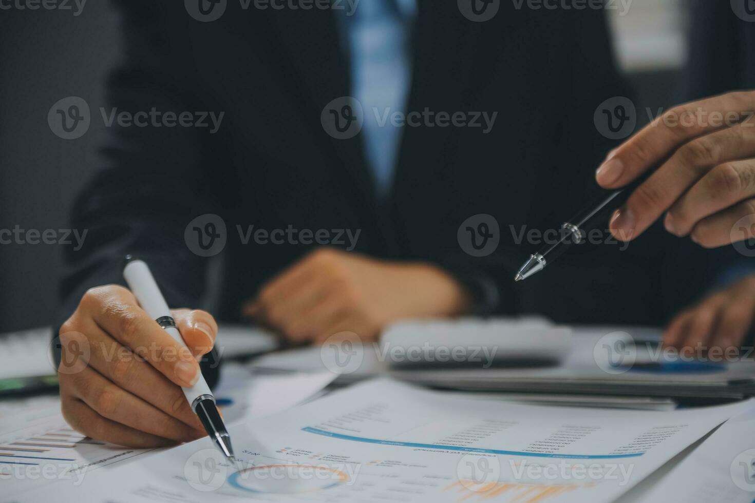 Financial analysts analyze business financial reports on a digital tablet planning investment project during a discussion at a meeting of corporate showing the results of their successful teamwork. photo