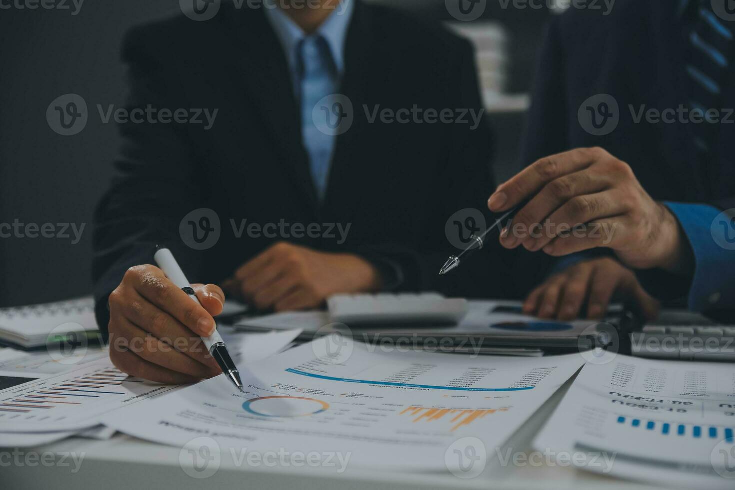 Financial analysts analyze business financial reports on a digital tablet planning investment project during a discussion at a meeting of corporate showing the results of their successful teamwork. photo