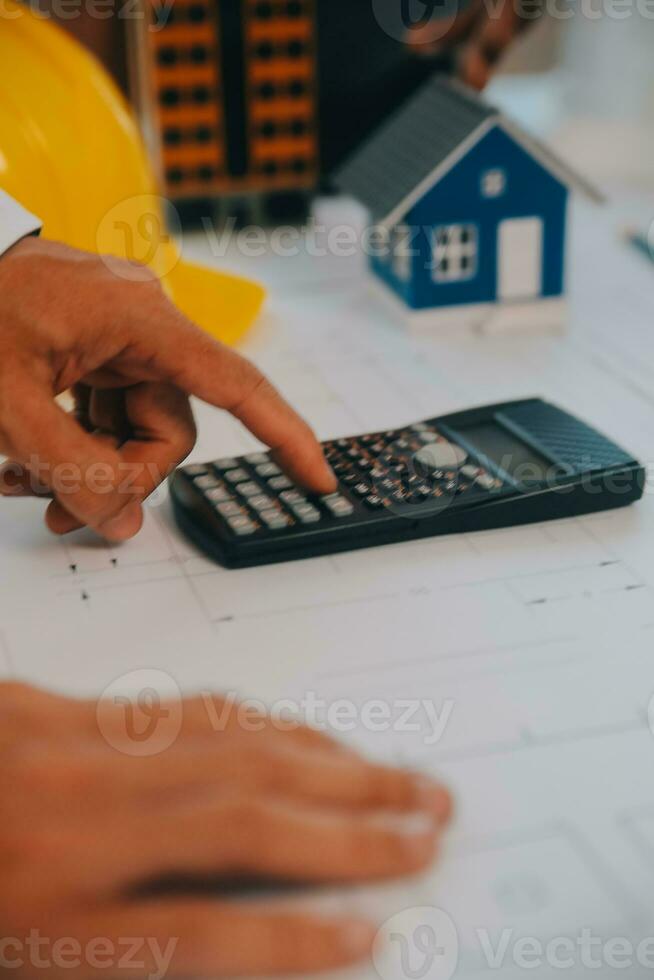 Construction and structure concept of Engineer or architect meeting for project working with partner and engineering tools on model building and blueprint in working site, contract for both companies. photo