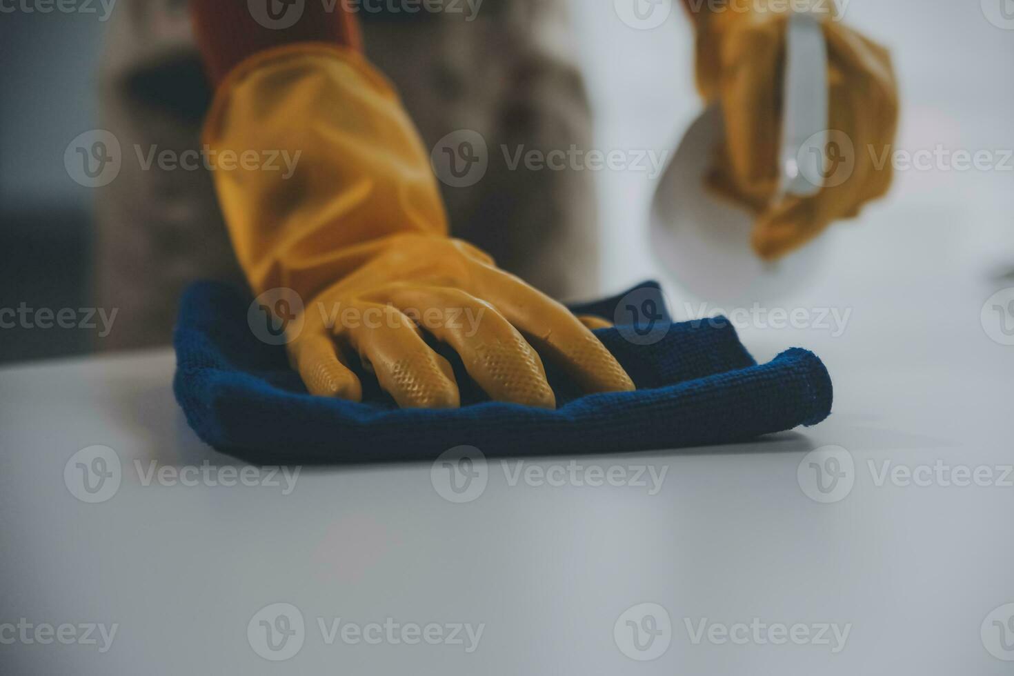 Office Cleaning Service. Janitor Spraying Desk. Workplace Hygiene photo