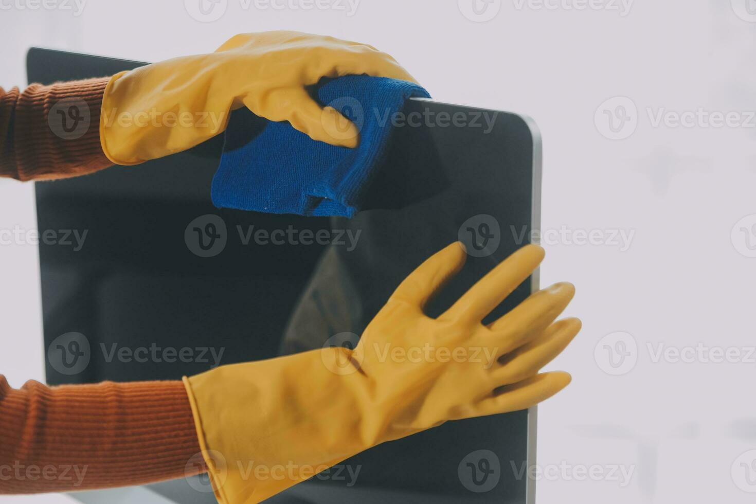 Office Cleaning Service. Janitor Spraying Desk. Workplace Hygiene photo