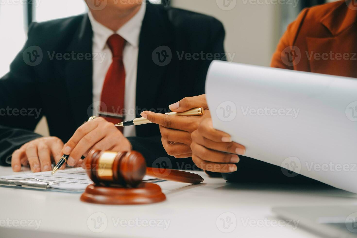 Business and lawyers discussing contract papers with brass scale on desk in office. Law, legal services, advice, justice and law concept picture with film grain effect photo