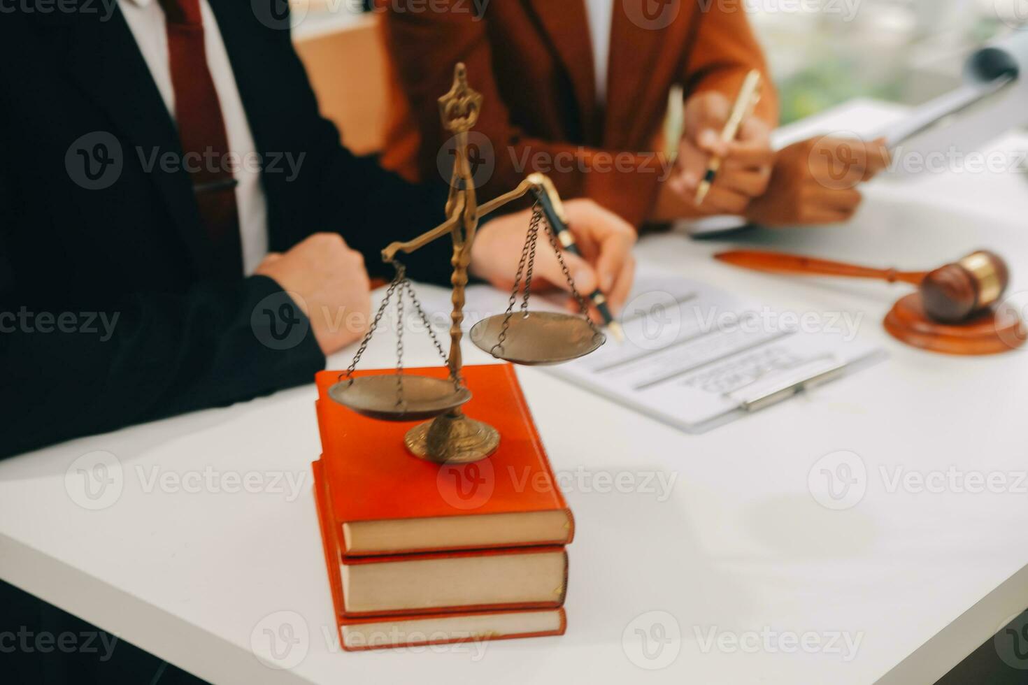 Business and lawyers discussing contract papers with brass scale on desk in office. Law, legal services, advice, justice and law concept picture with film grain effect photo
