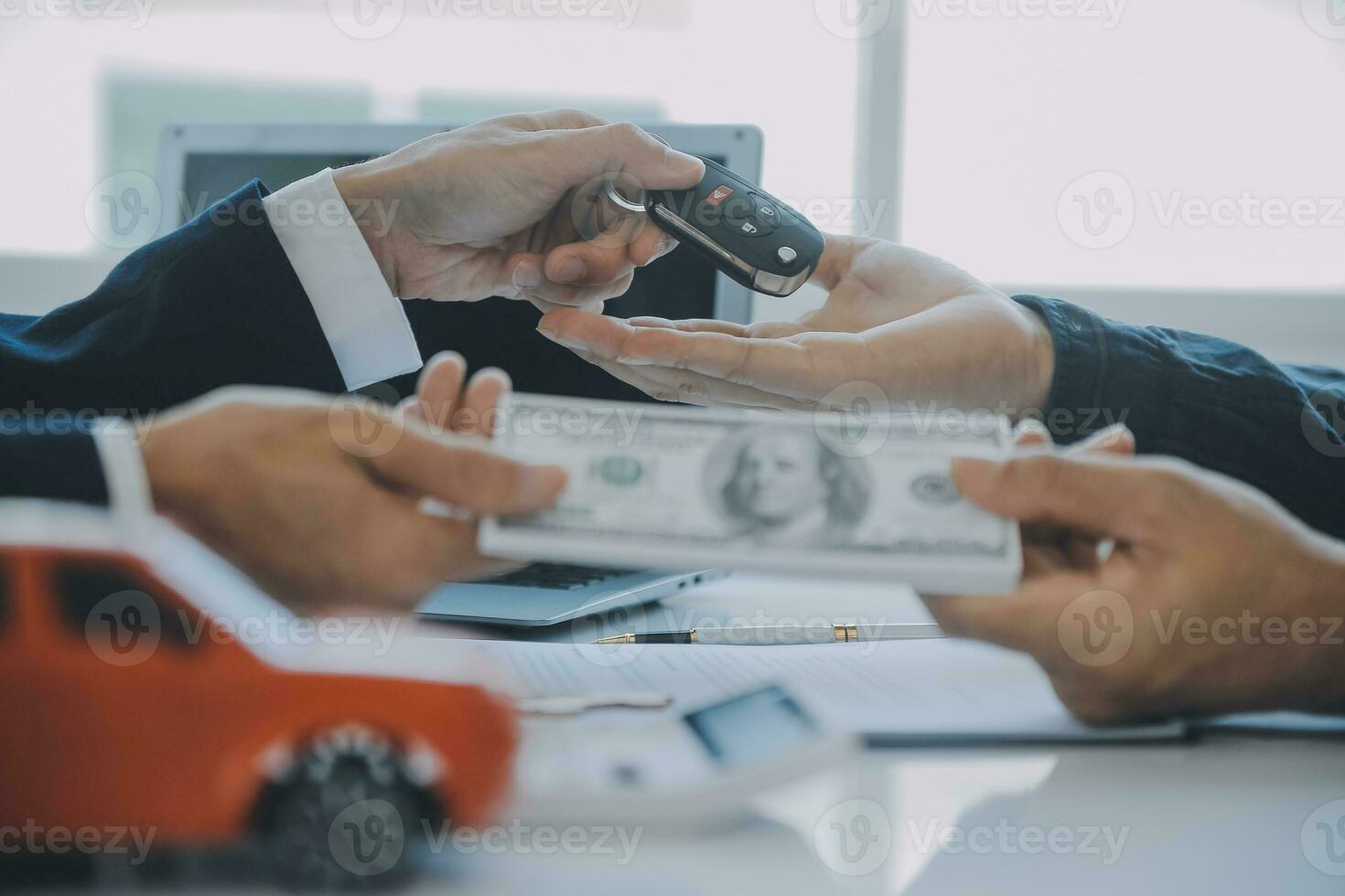 Closeup asian male people car salesman or sales manager offers to sell a car and explains and reads the terms of signing a car contract and insurance. photo