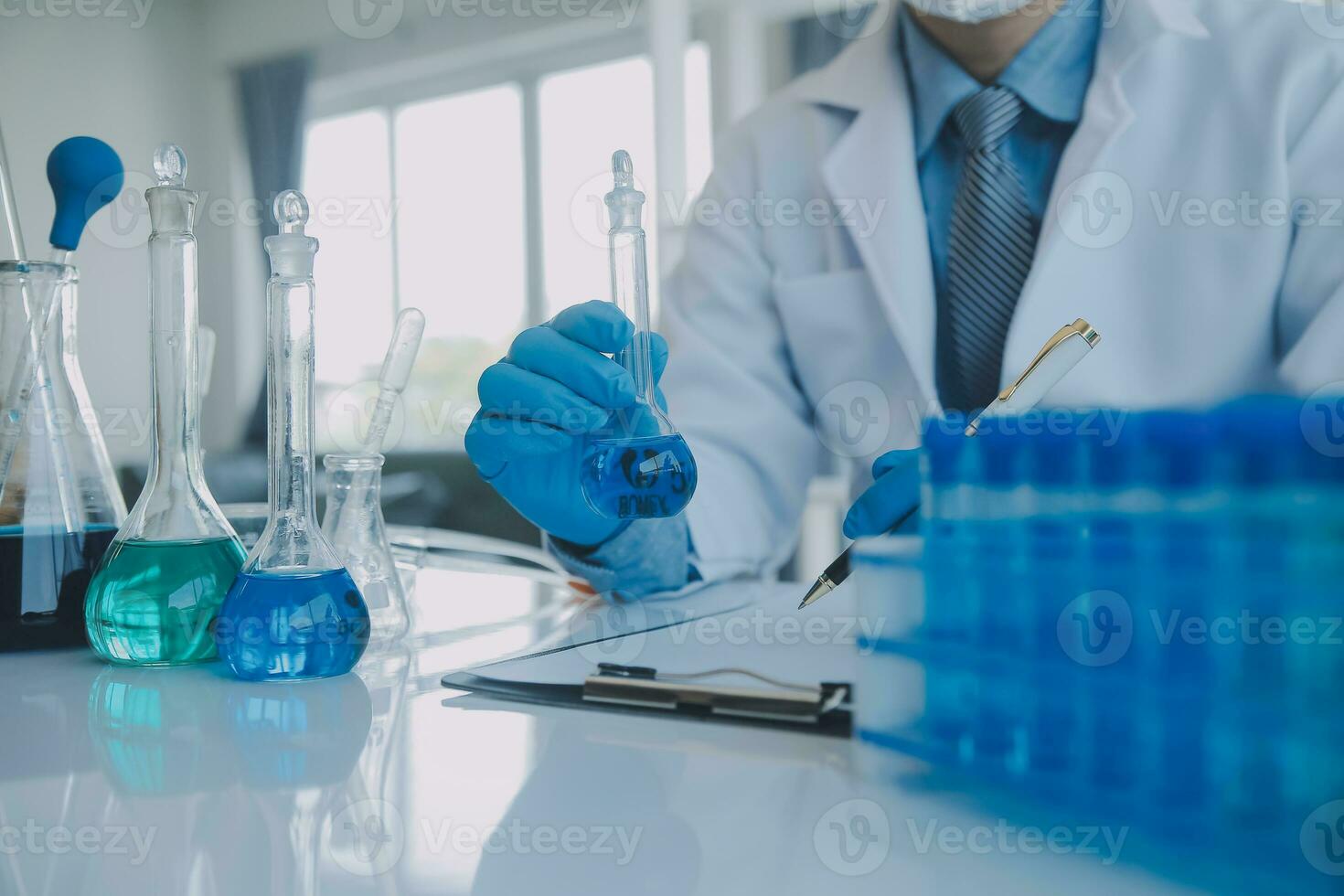 biochemical research scientist team working with microscope for coronavirus vaccine development in pharmaceutical research labolatory, selective focus photo