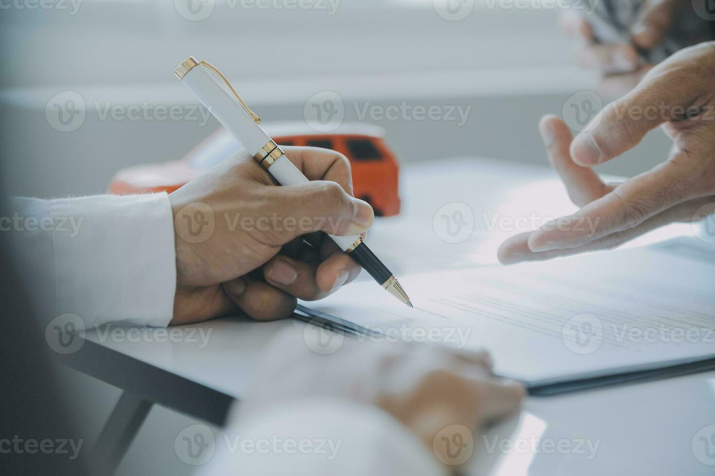 Closeup asian male people car salesman or sales manager offers to sell a car and explains and reads the terms of signing a car contract and insurance. photo