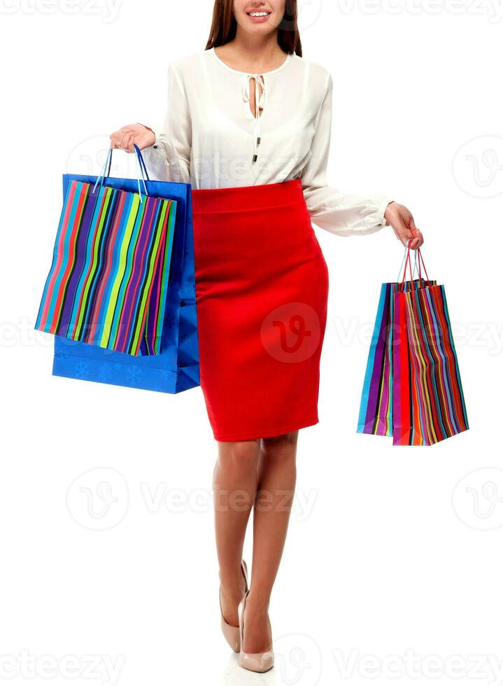 Pretty woman with shopping bags. Isolated photo