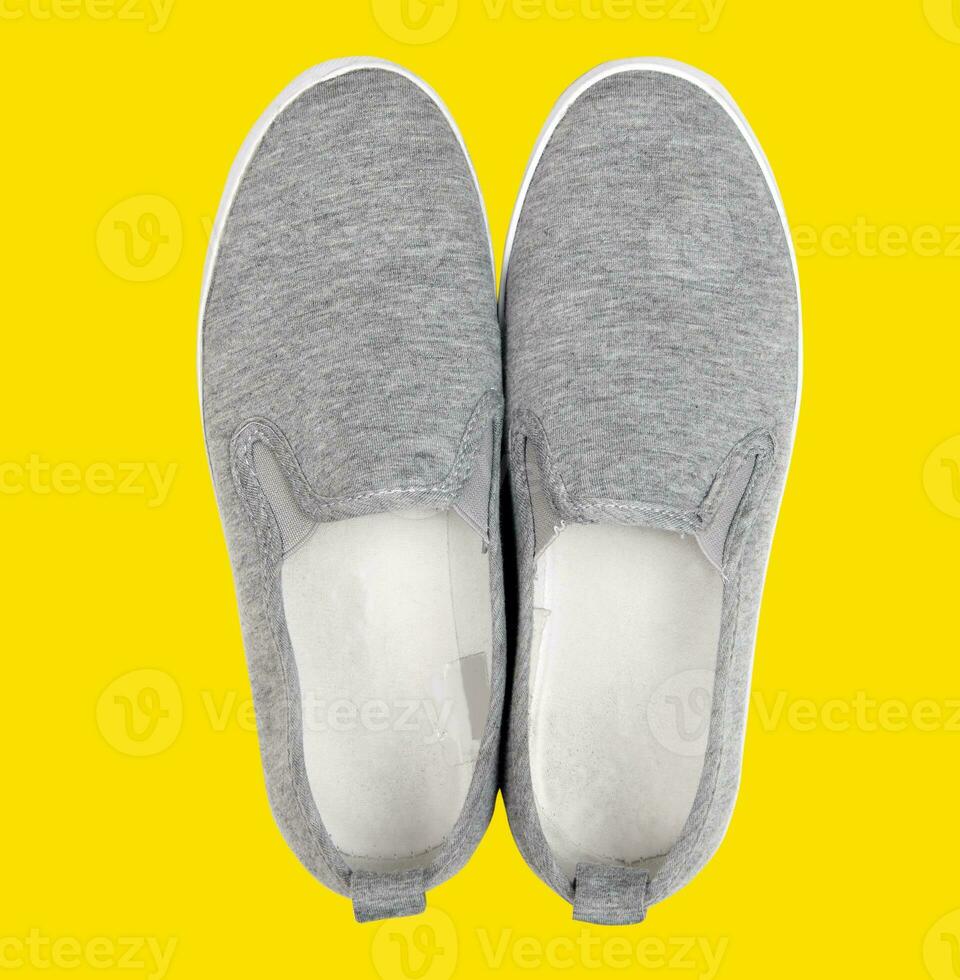 Casual shoes on yellow background photo