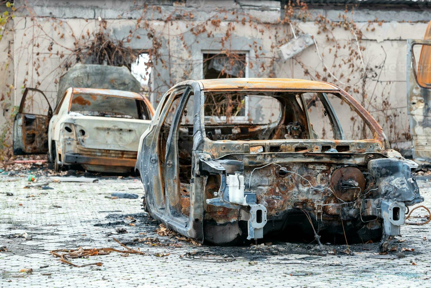 damaged and looted cars in a city in Ukraine during the war photo