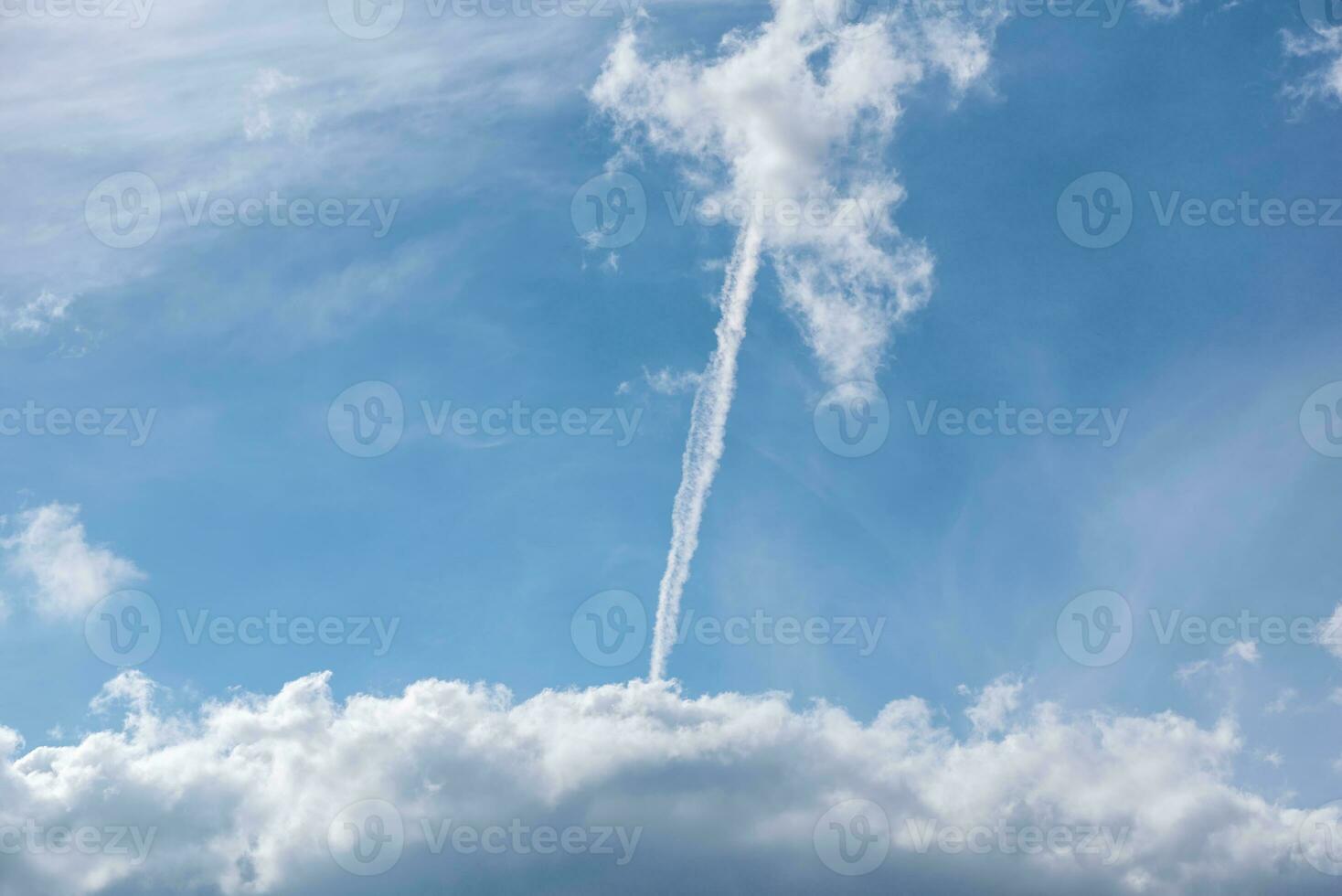 contrail of a rocket launch in the blue sky in Ukraine photo