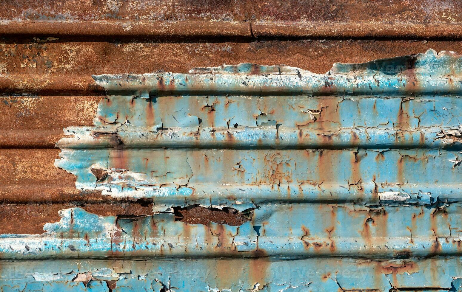 pattern rusty metal surface with remnants of blue paint photo