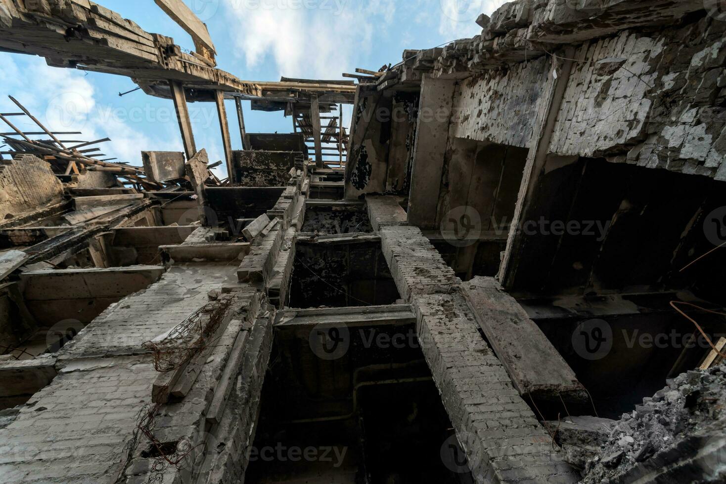 destroyed and burned houses in the city during the war in Ukraine photo