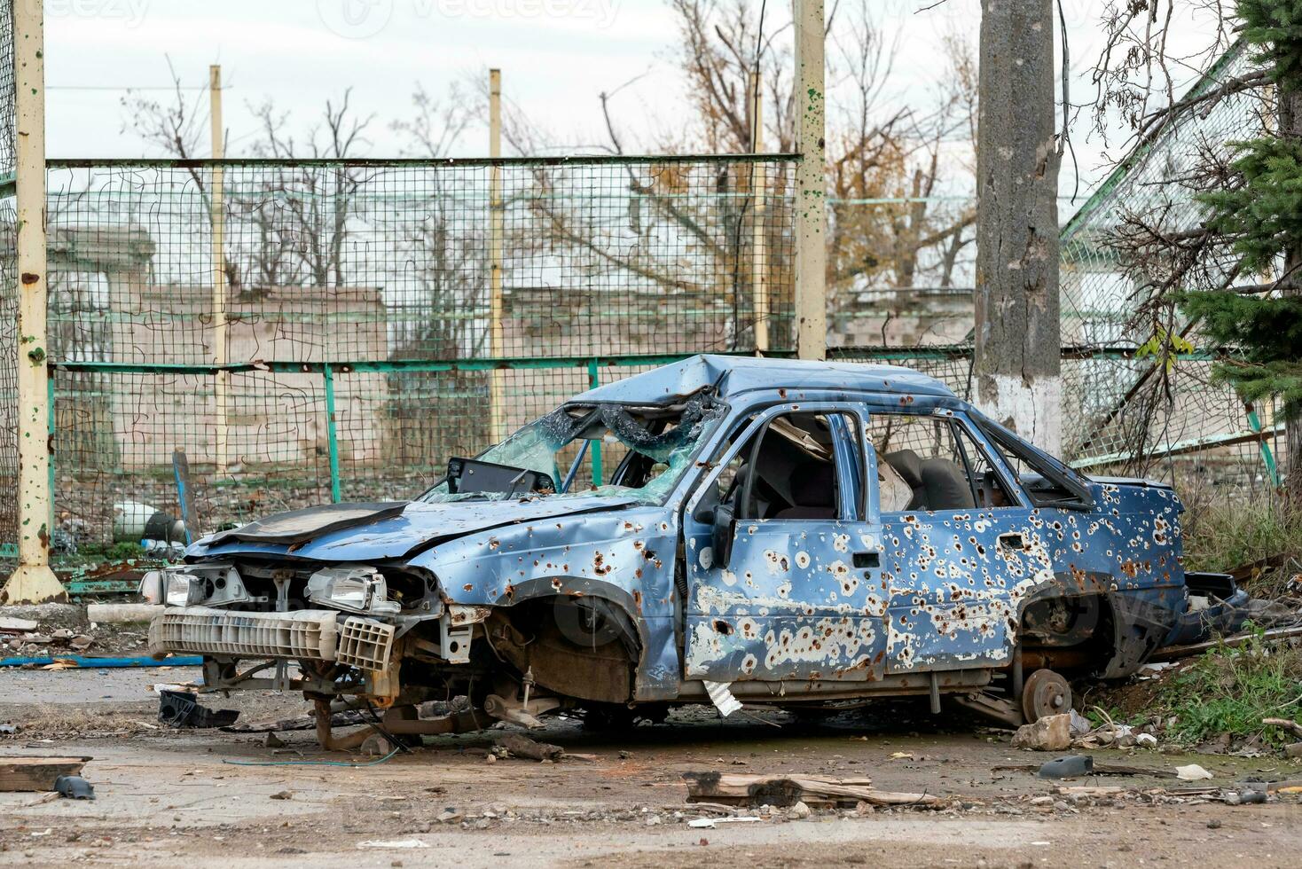 burnt car and destroyed buildings of the workshop of the Azovstal plant in Mariupol photo