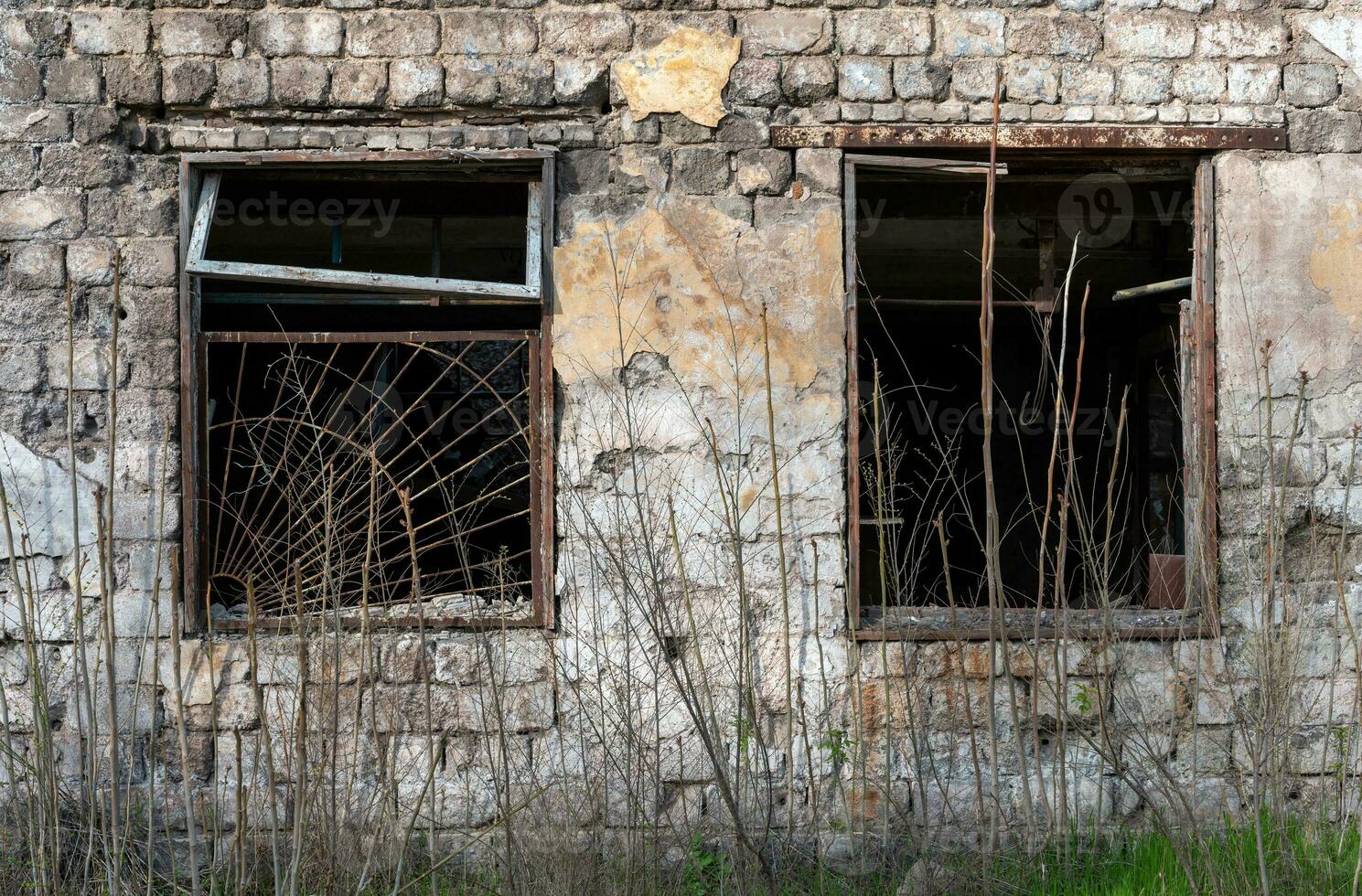 empty windows of a damaged house in Ukraine photo