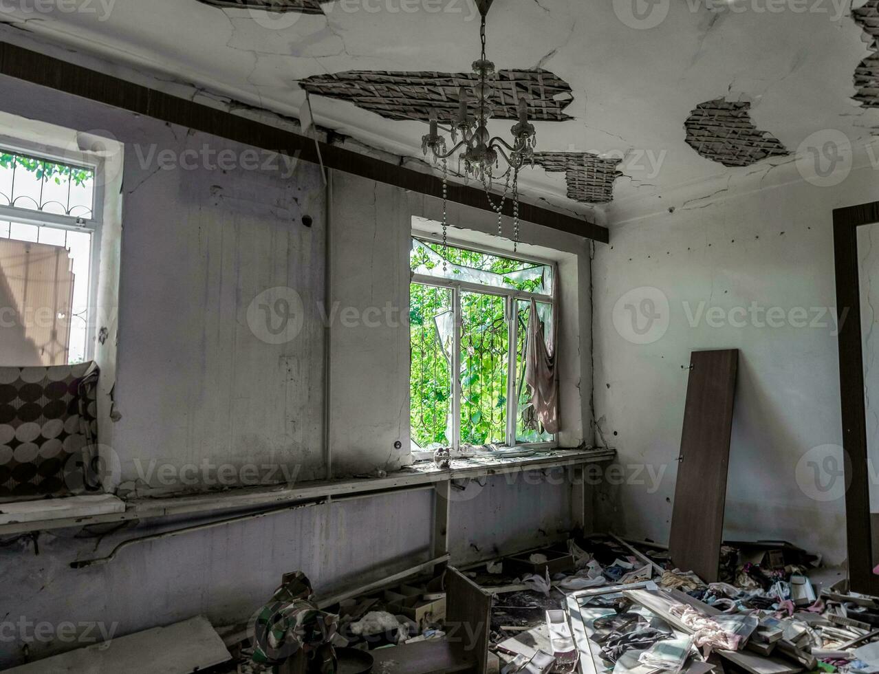 inside a destroyed house without people in an abandoned city in Ukraine photo