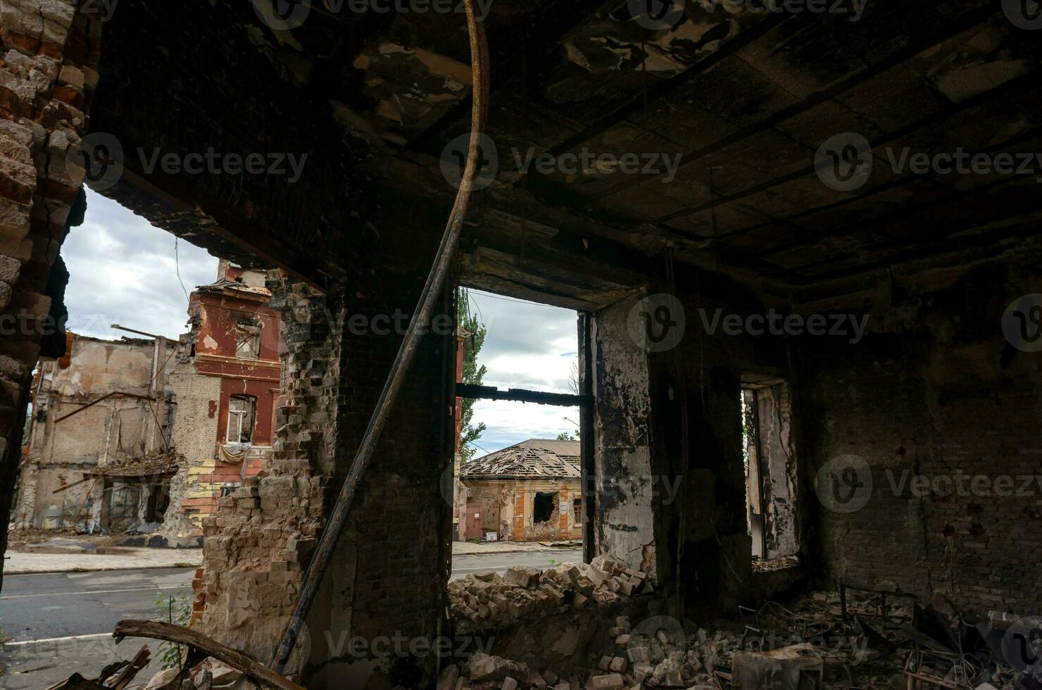 destroyed and burned houses in the city during the war in Ukraine photo
