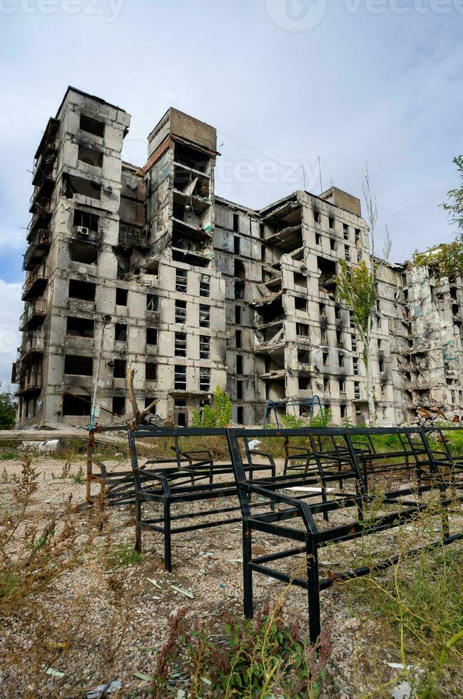 destroyed and burned houses in the city during the war in Ukraine photo