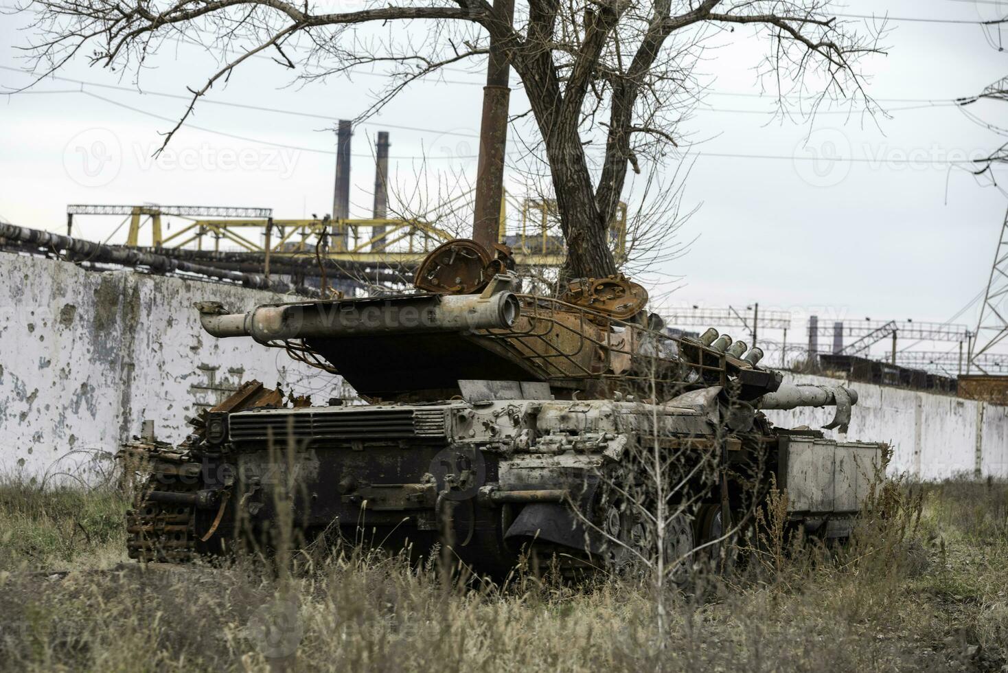 burnt tank and destroyed buildings of the Azovstal plant shop in Mariupol photo