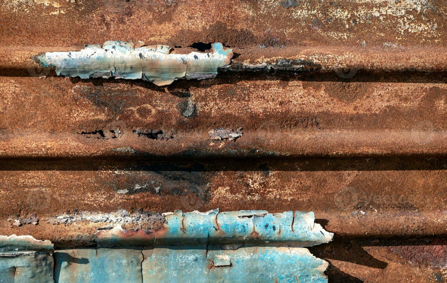pattern rusty metal surface with remnants of blue paint photo