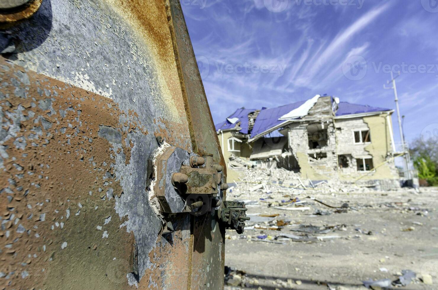 burnt military armored car on the street of the ruined city photo