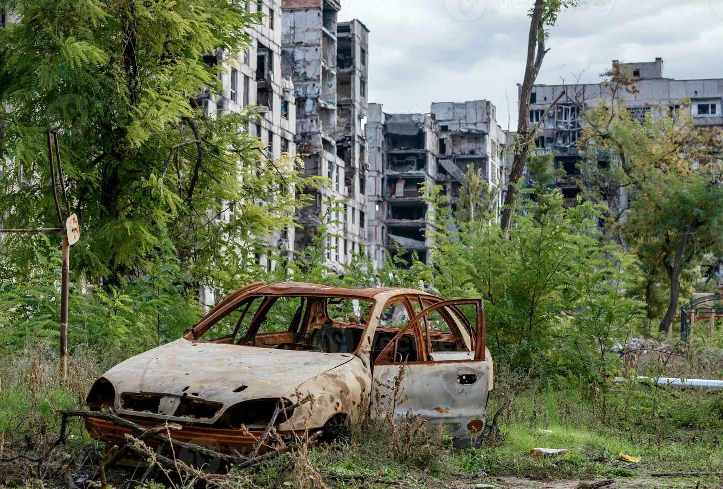 destroyed and burned houses in the city during the war in Ukraine photo