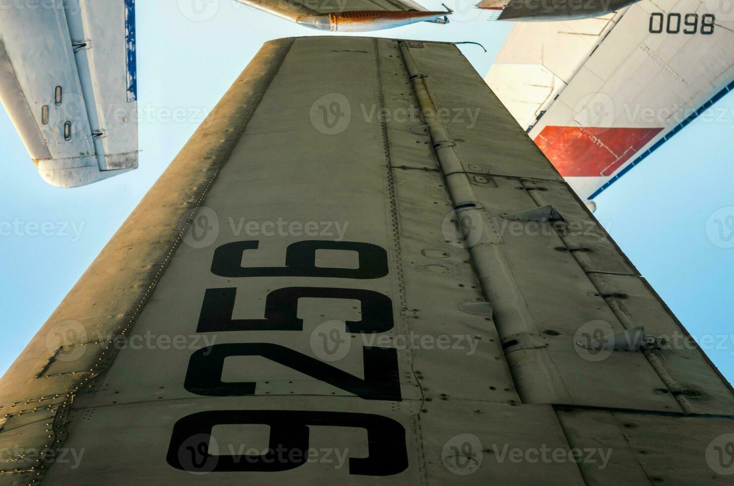 wing with tail number on the background of airplanes and blue sky photo