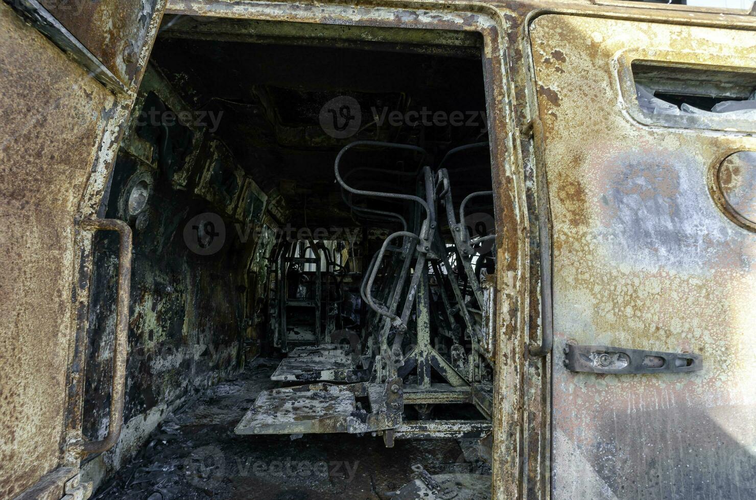 burnt military armored car on the street of the ruined city photo