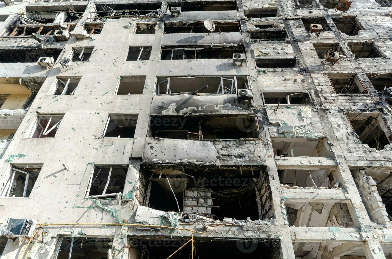 destroyed and burned houses in the city during the war in Ukraine photo