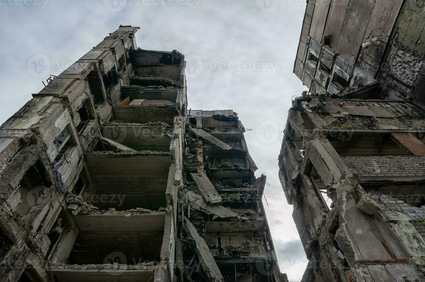 destroyed and burned houses in the city during the war in Ukraine photo