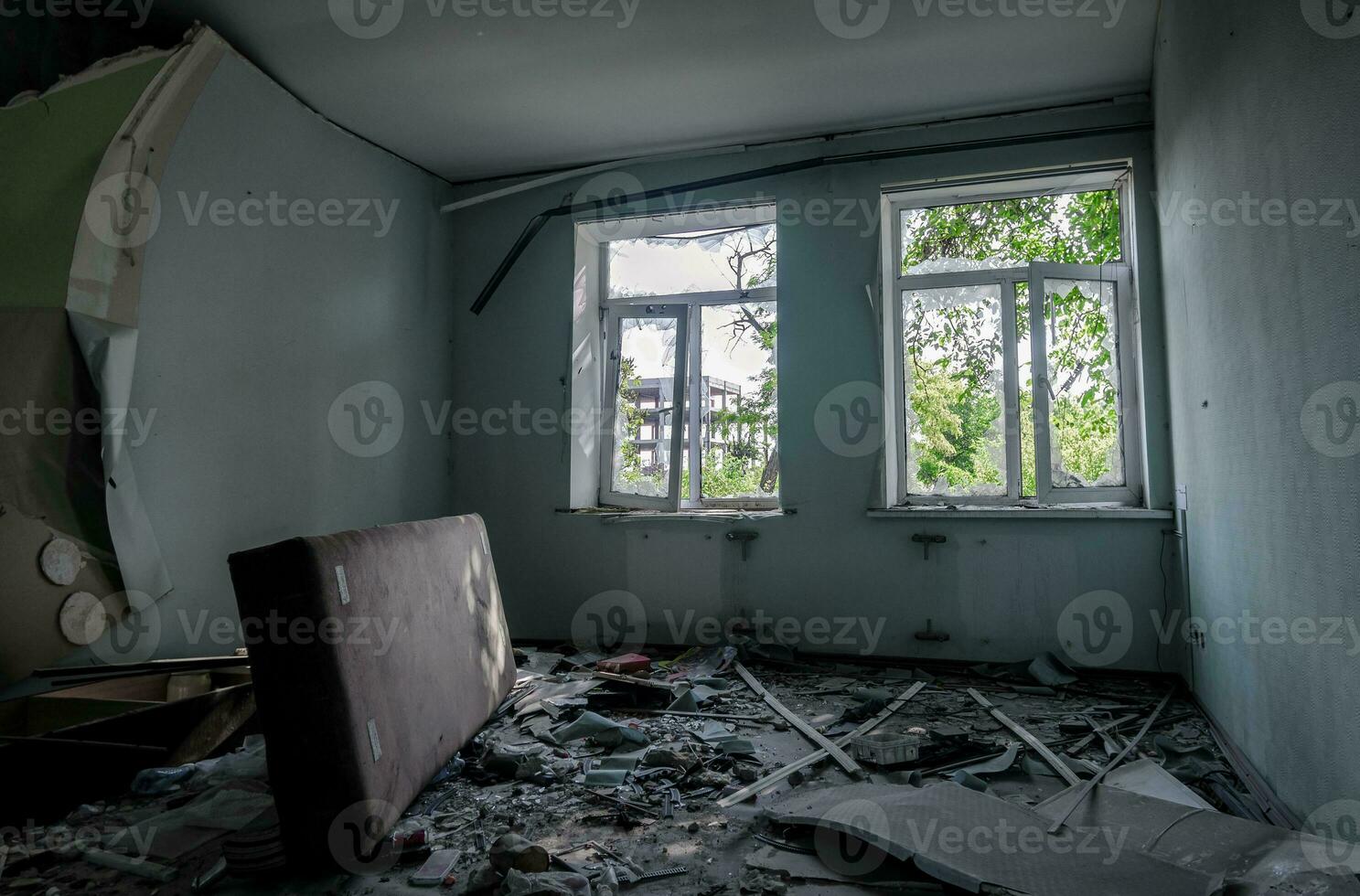 inside a destroyed house without people in an abandoned city in Ukraine photo