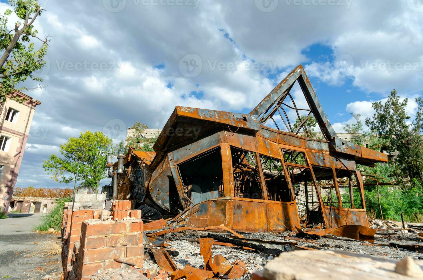 destroyed and burned houses in the city during the war in Ukraine photo