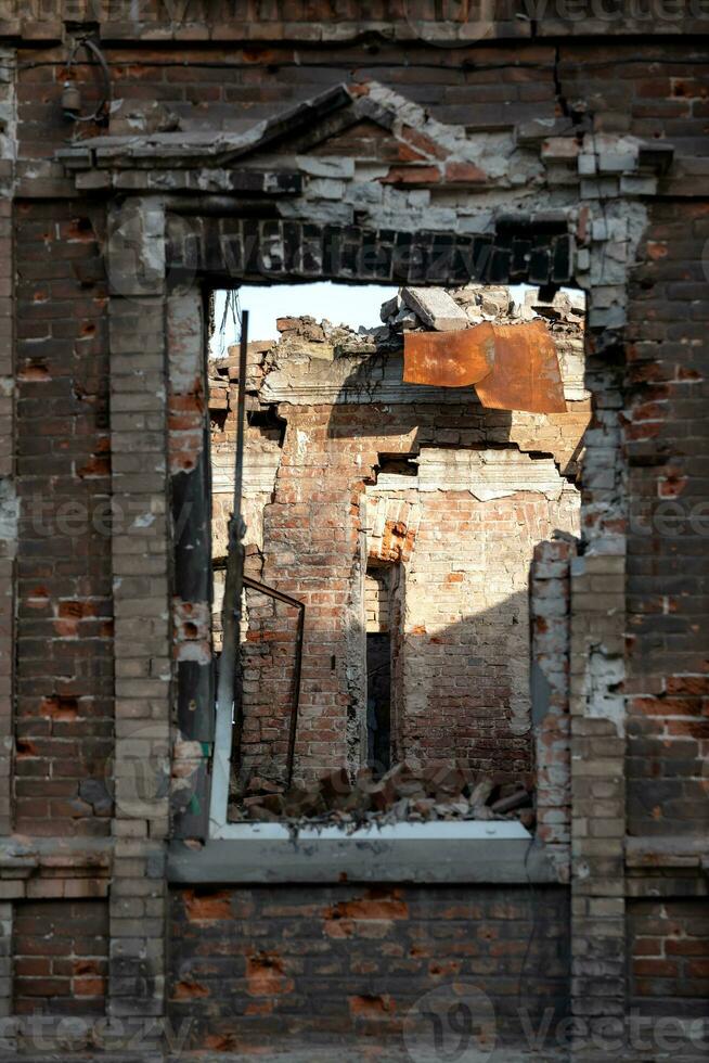 empty windows of a damaged house in Ukraine photo