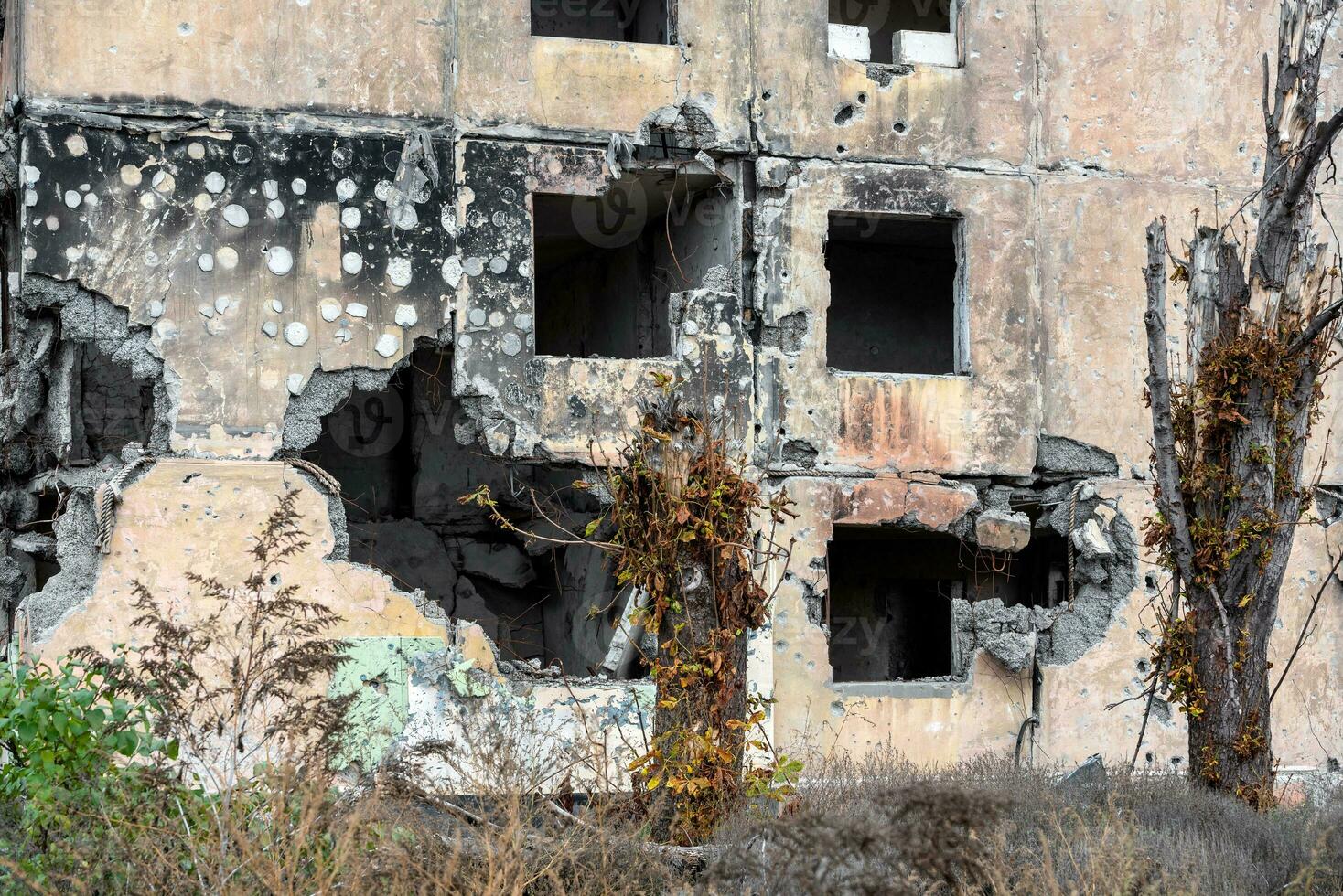 destroyed and burned houses in the city during the war in Ukraine photo