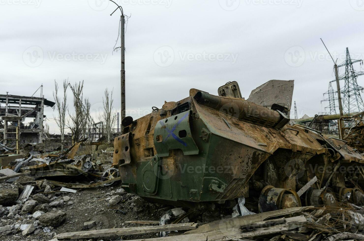 burnt tank and destroyed buildings of the Azovstal plant shop in Mariupol photo