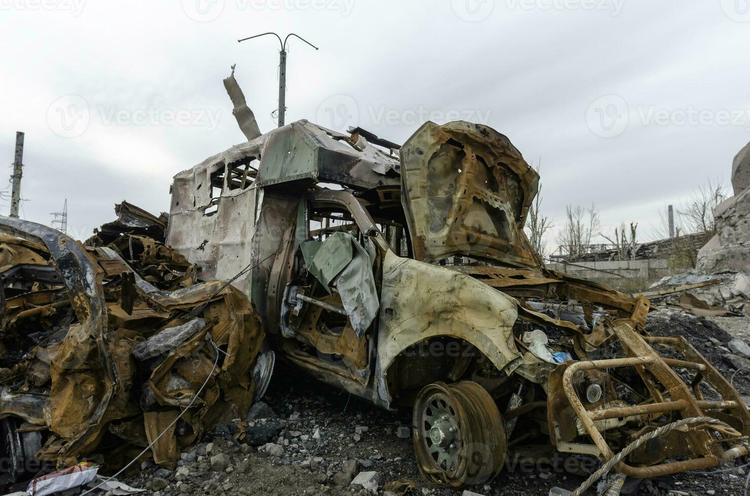 burnt cars and destroyed buildings of the workshop of the Azovstal plant in Mariupol photo