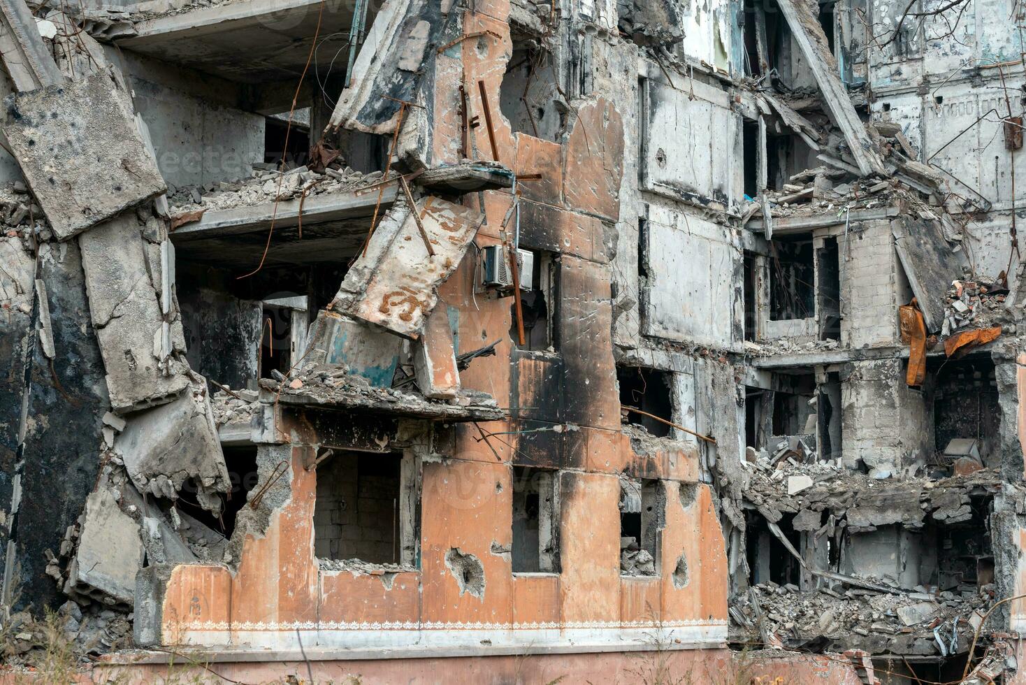 destroyed and burned houses in the city during the war in Ukraine photo