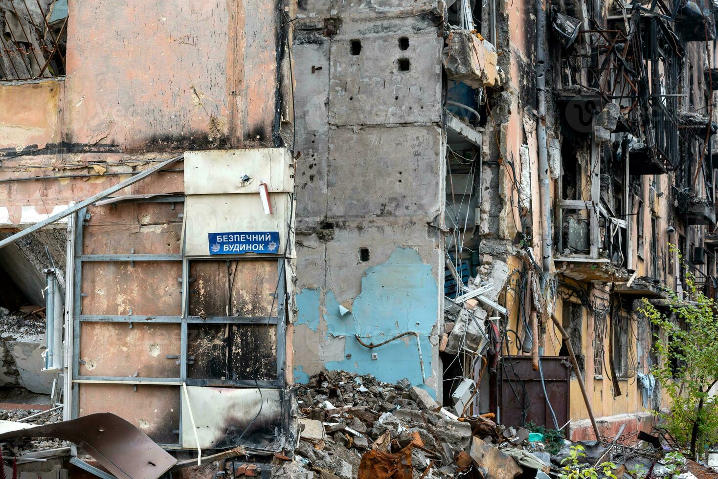 plate text in Ukrainian safe house on the wall of a destroyed and burned house war in Ukraine with Russia photo