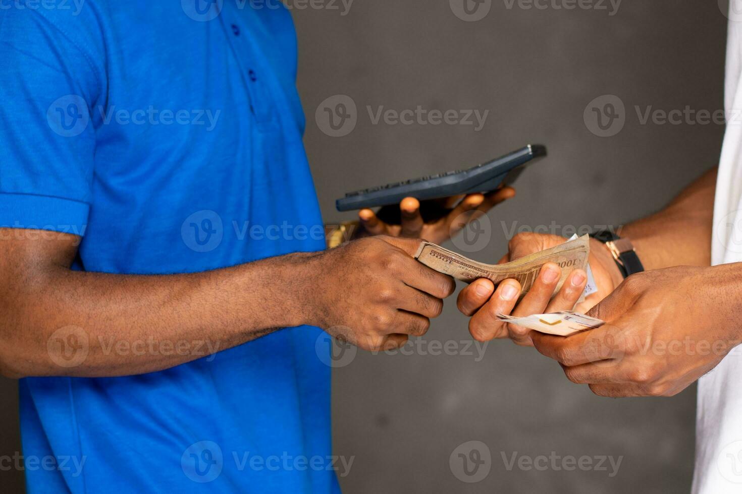 people transacting, holding money and calculator photo
