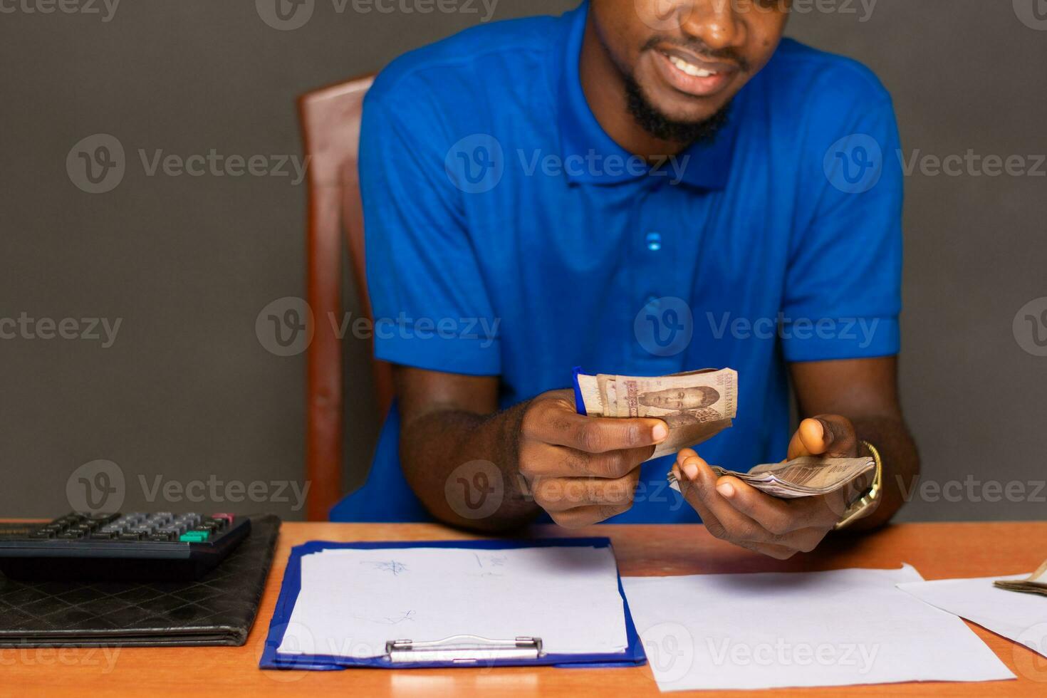 young black man doing some financial calculations photo