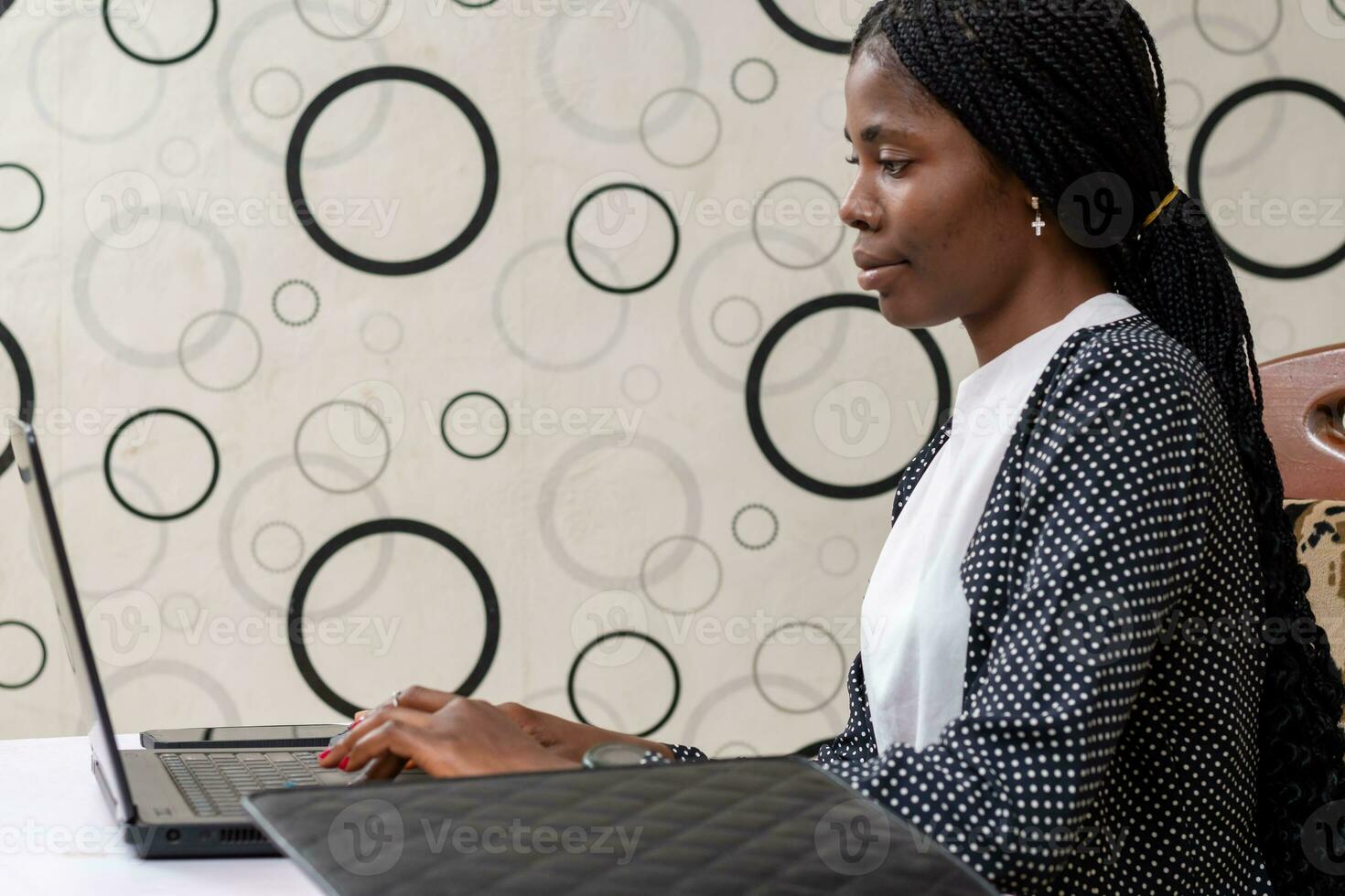 successful african businesswoman seriously focusing on her work photo