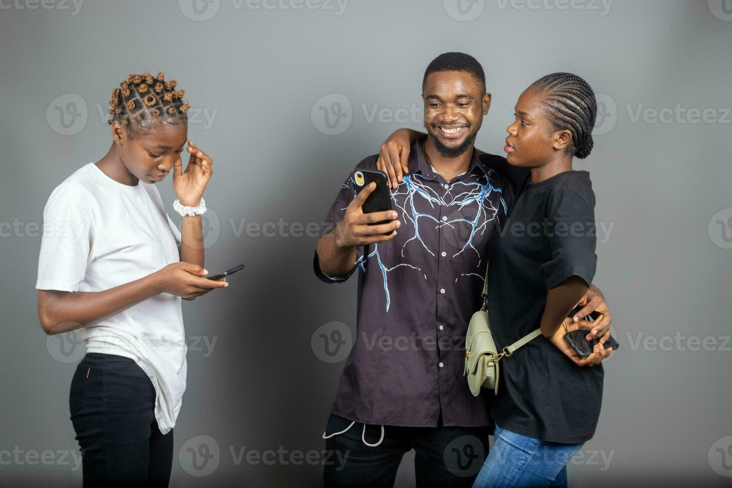 group of young african student feeling excited about the saw on their cellphone photo