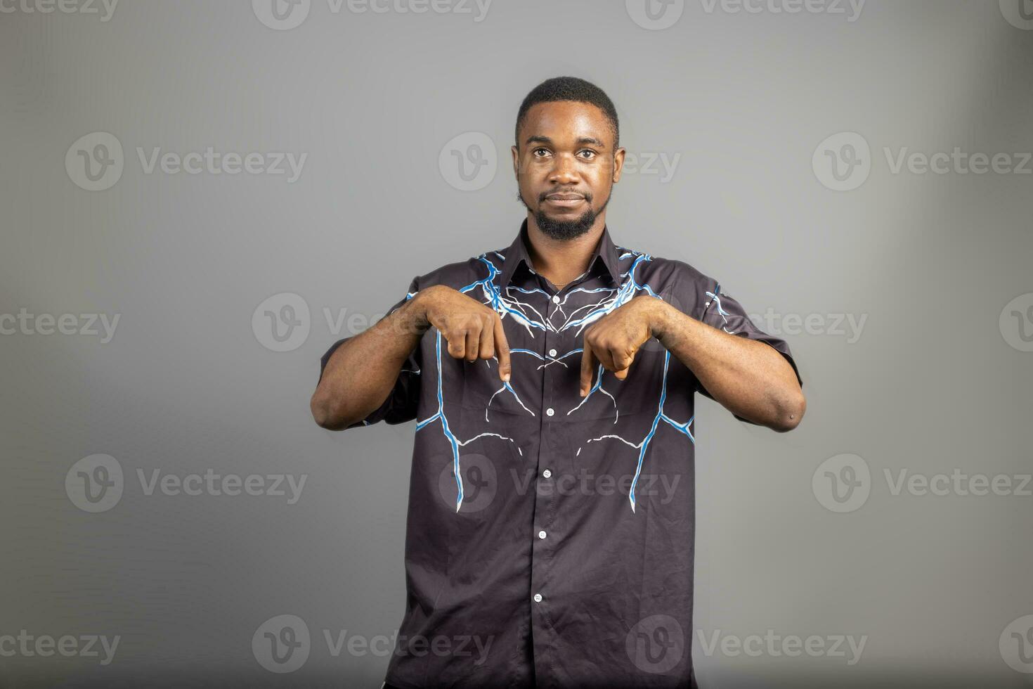 Photo of astonished cheerful man indicate fingers empty space isolated on white color background