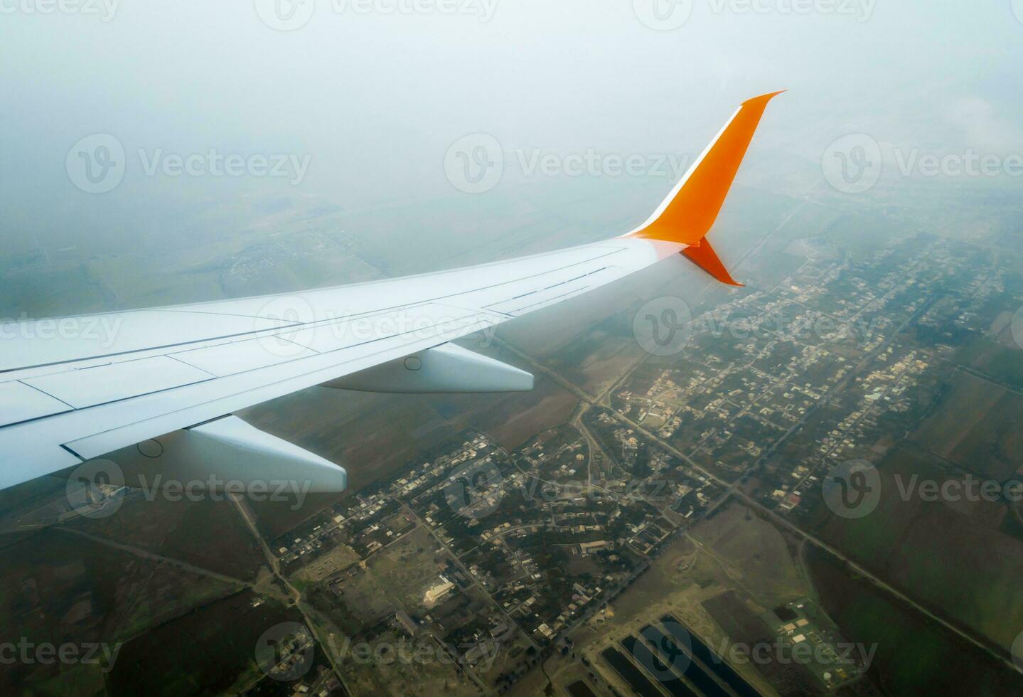 wing of a flying civil airliner over the city of Georgia photo