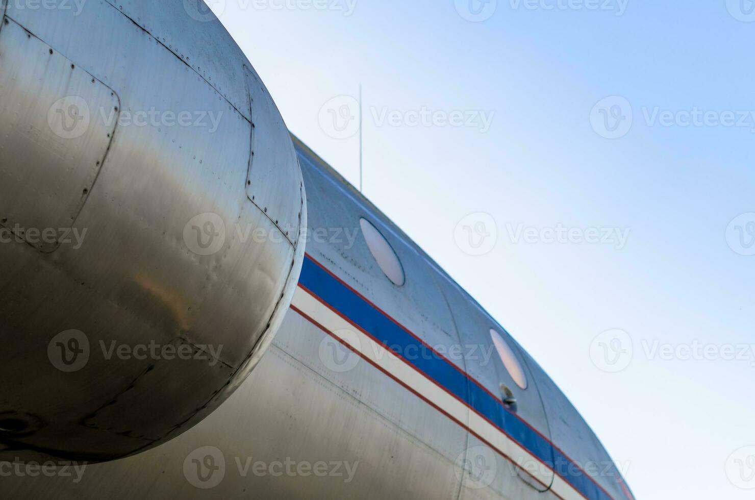 airplane body with portholes and turbine photo