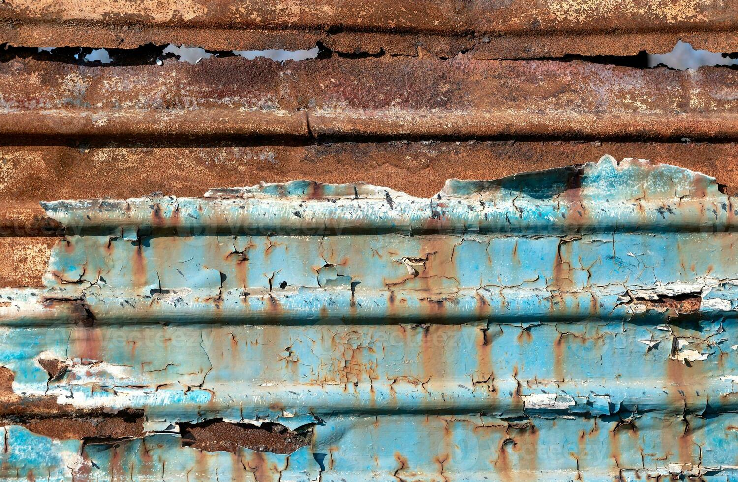 pattern rusty metal surface with remnants of blue paint photo